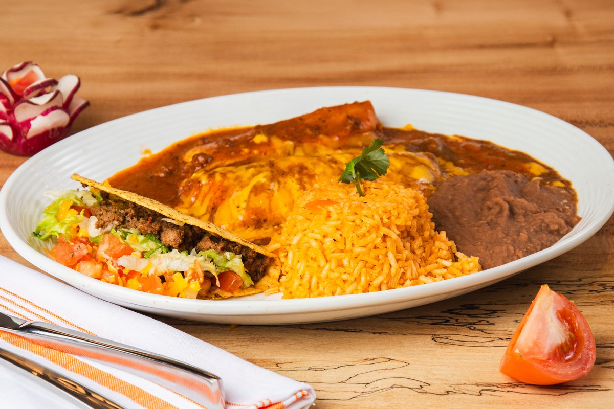 Mexican dinner plate with enchiladas, rice and beans