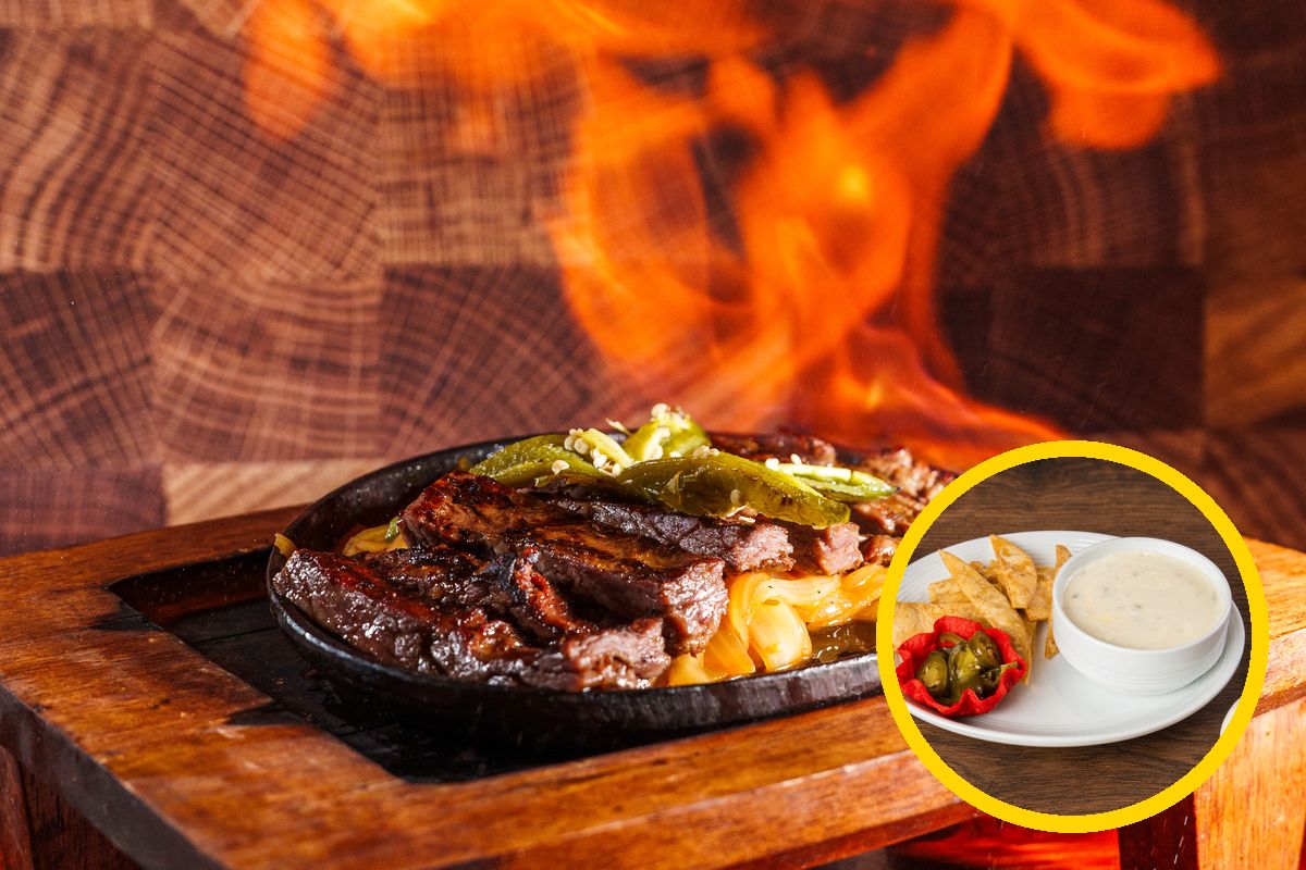 Sizzling beef fajitas with a bowl of chile con queso